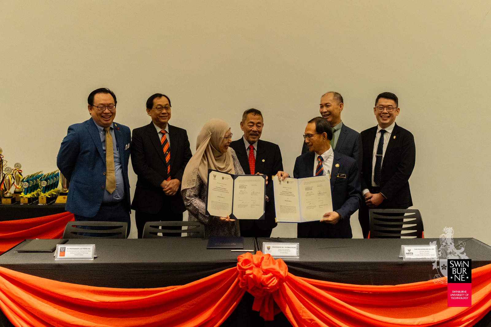 Professor Dr Yatimah Alias (third left) and Tuan Haji Adana bin Haji Jed (fifth left) hold up the signed MoU between UM and the Ministry of Education, Innovation and Talent Development Sarawak.