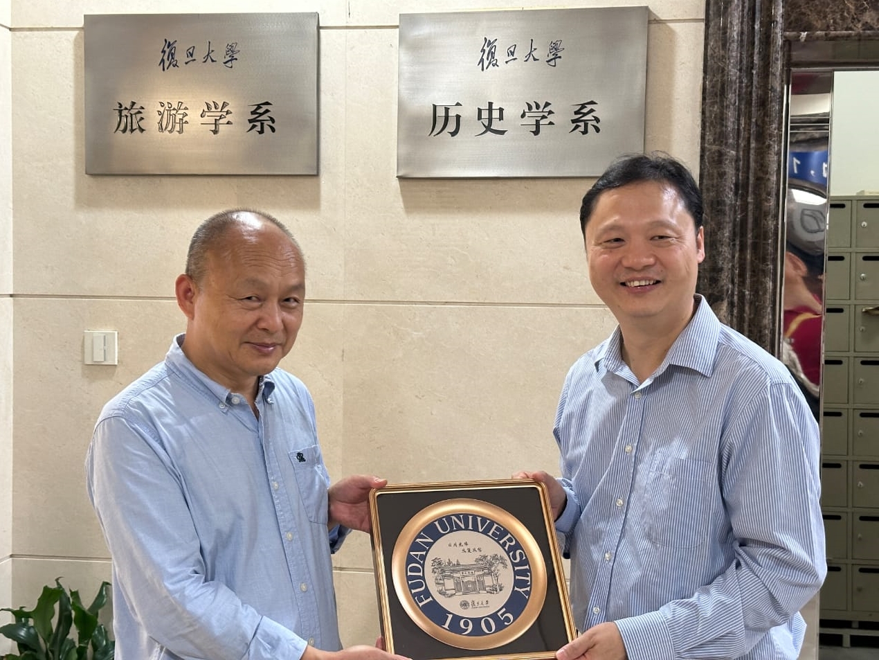 Professor Huang Yang (left), Dean of Fudan University’s Department of History, presents a memento to Professor Wallace Wong.