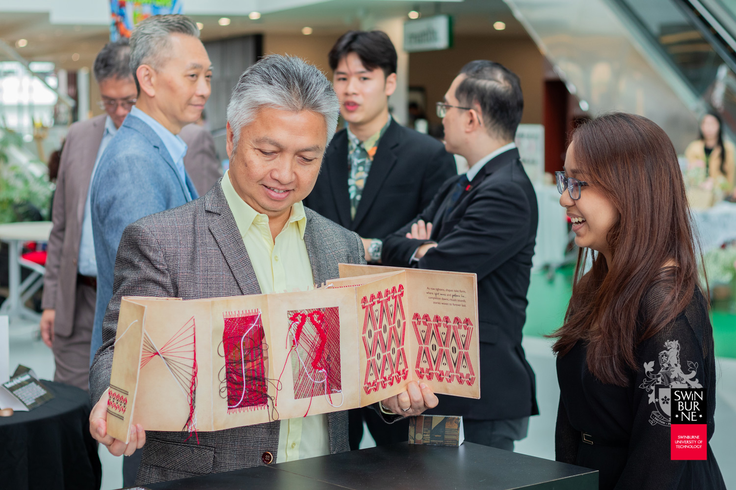 YB Datuk Snowdan Lawan (left) explores a student’s project, inspired by Pua Kumbu.