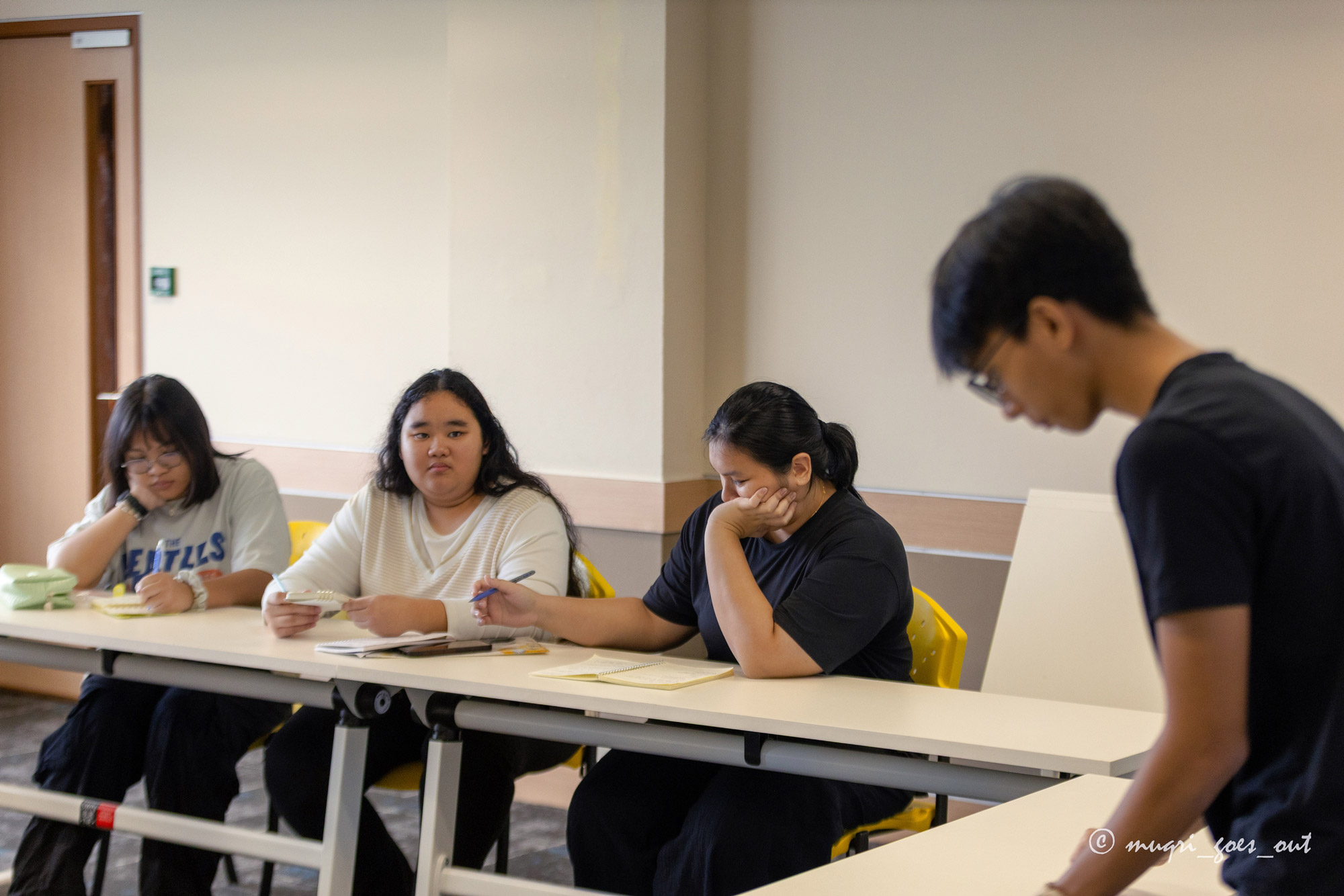 The students participate in a practice debate session. 